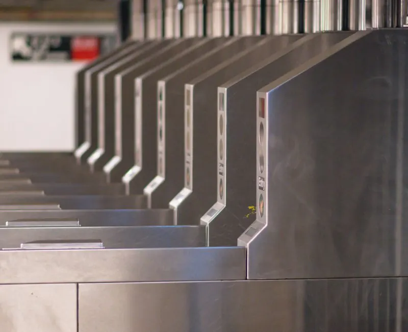A detailed shot of multiple subway entrance turnstiles, emphasizing public transportation.